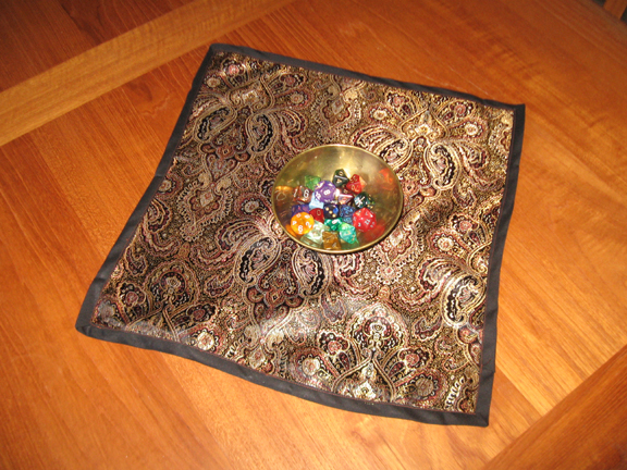 A brass bowl with dice